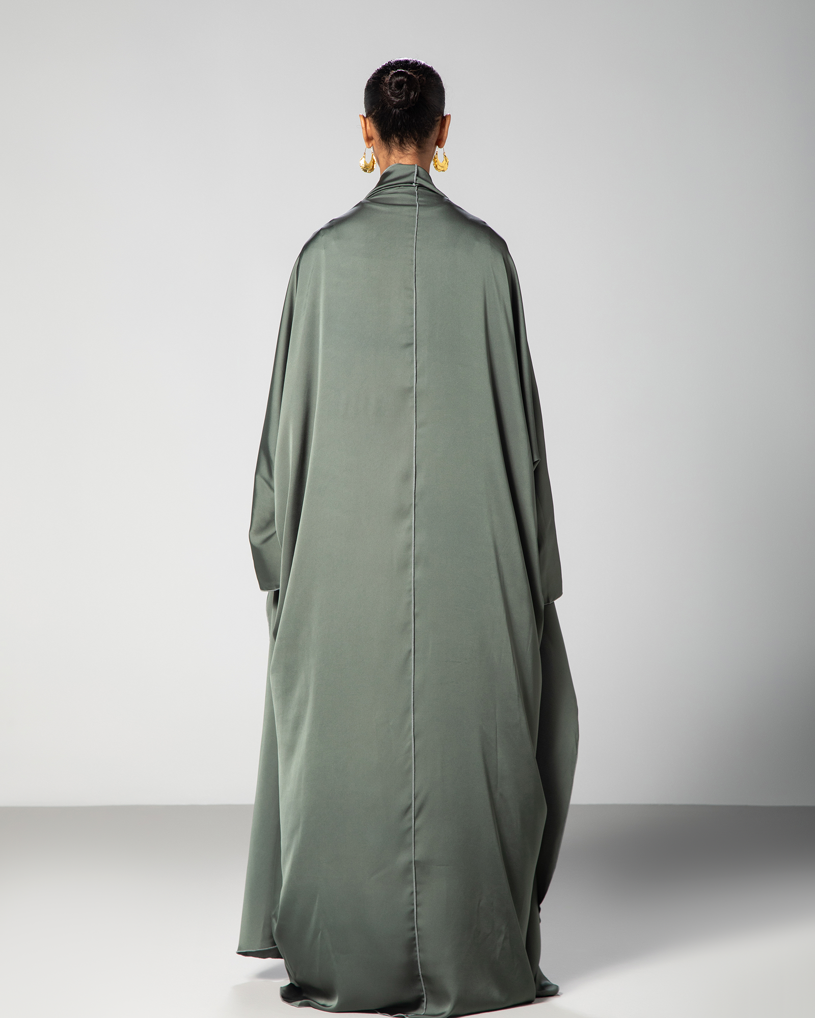 Back view of green Flow Abaya showcasing fluid cut and elegant drape – UAE, KSA, Qatar