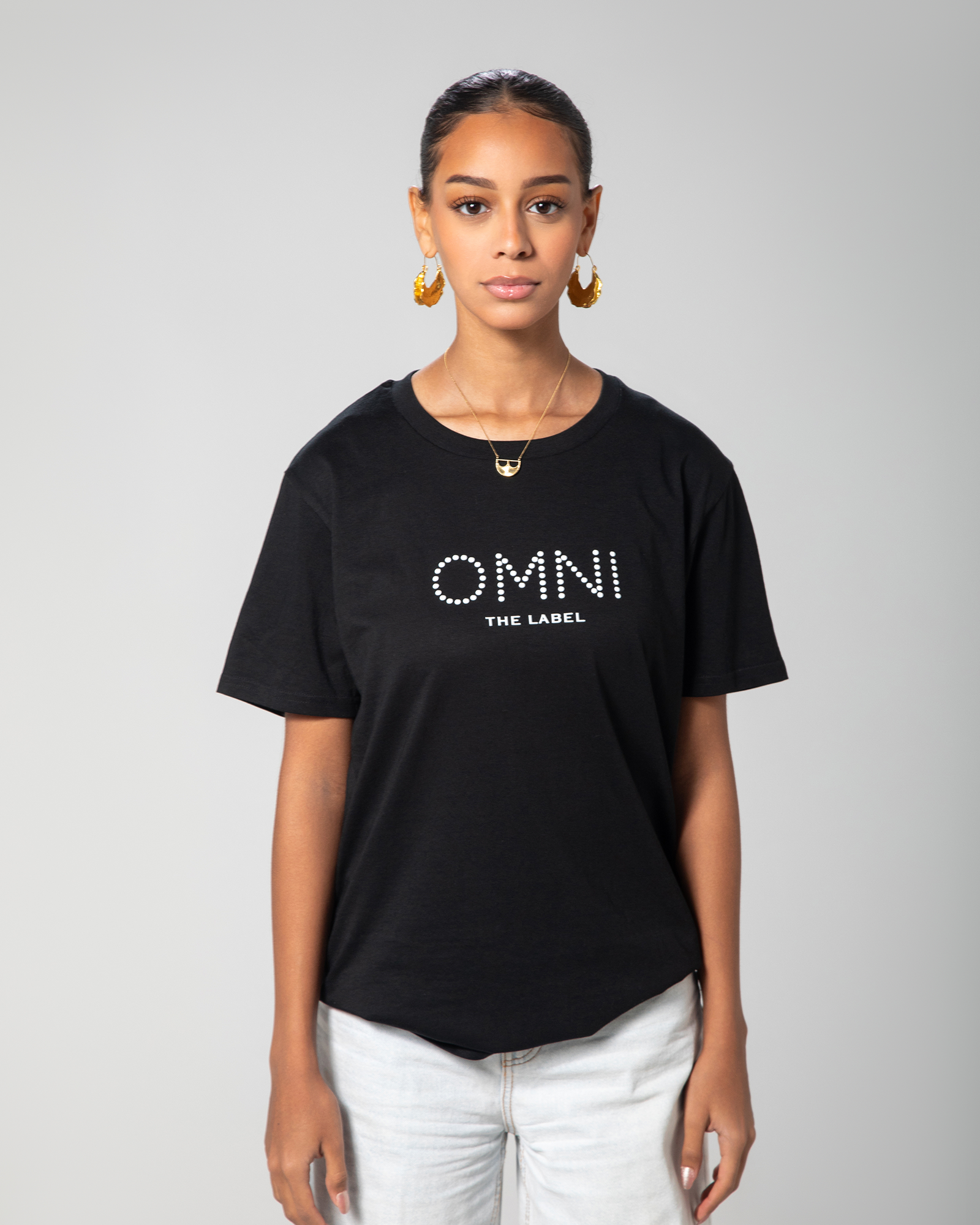 Front view of Omni The Label’s black fitted T-shirt with clean lines and minimal design, featuring the logo printed in white across the chest.