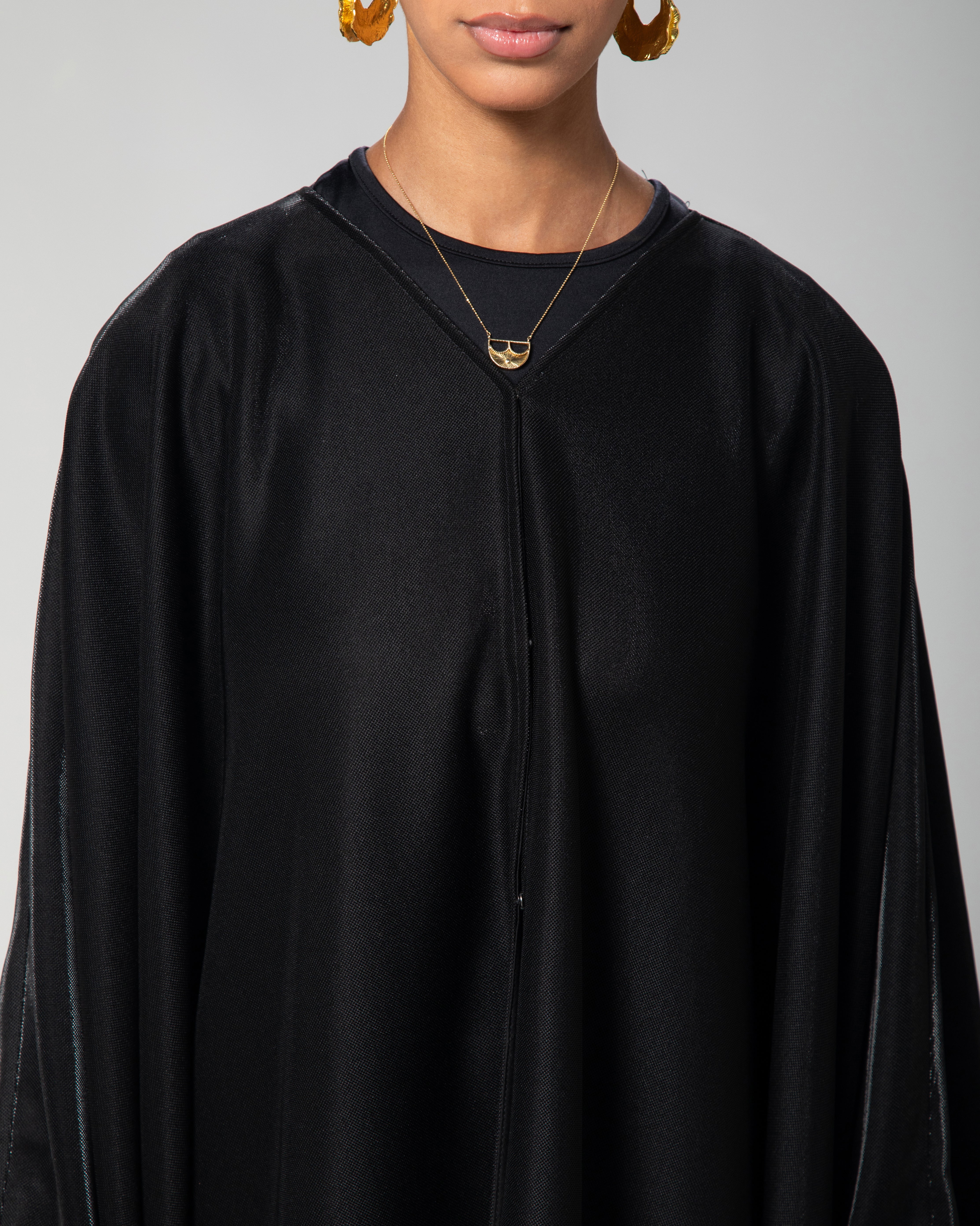 Elegant black abaya cover-up with subtle shimmer, fashion by Omni The Label KSA UAE Qatar
