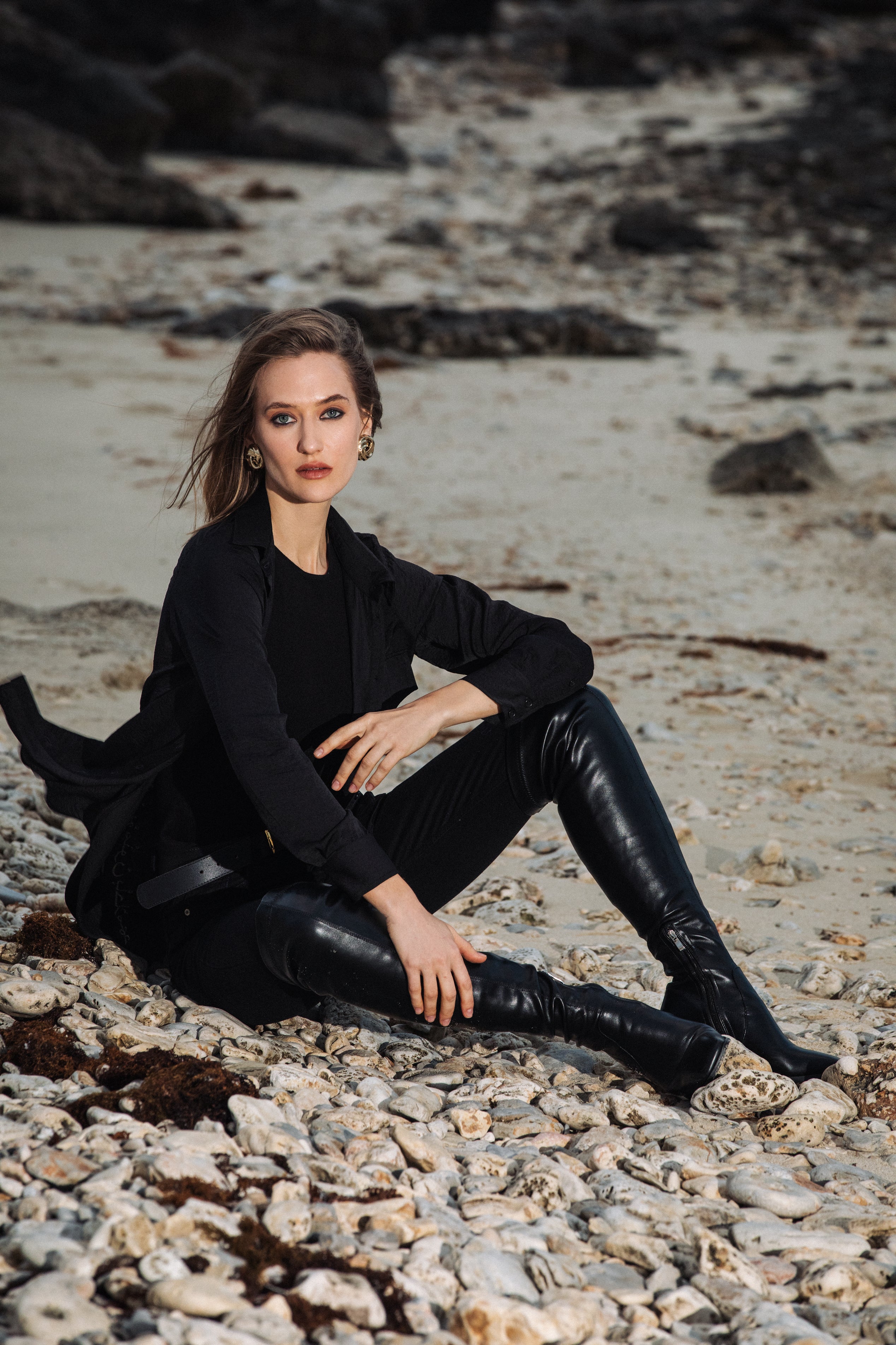 Outdoor editorial shot of model wearing the black shirt with jeans, styled casually by Omni The Label – UAE, KSA, Qatar