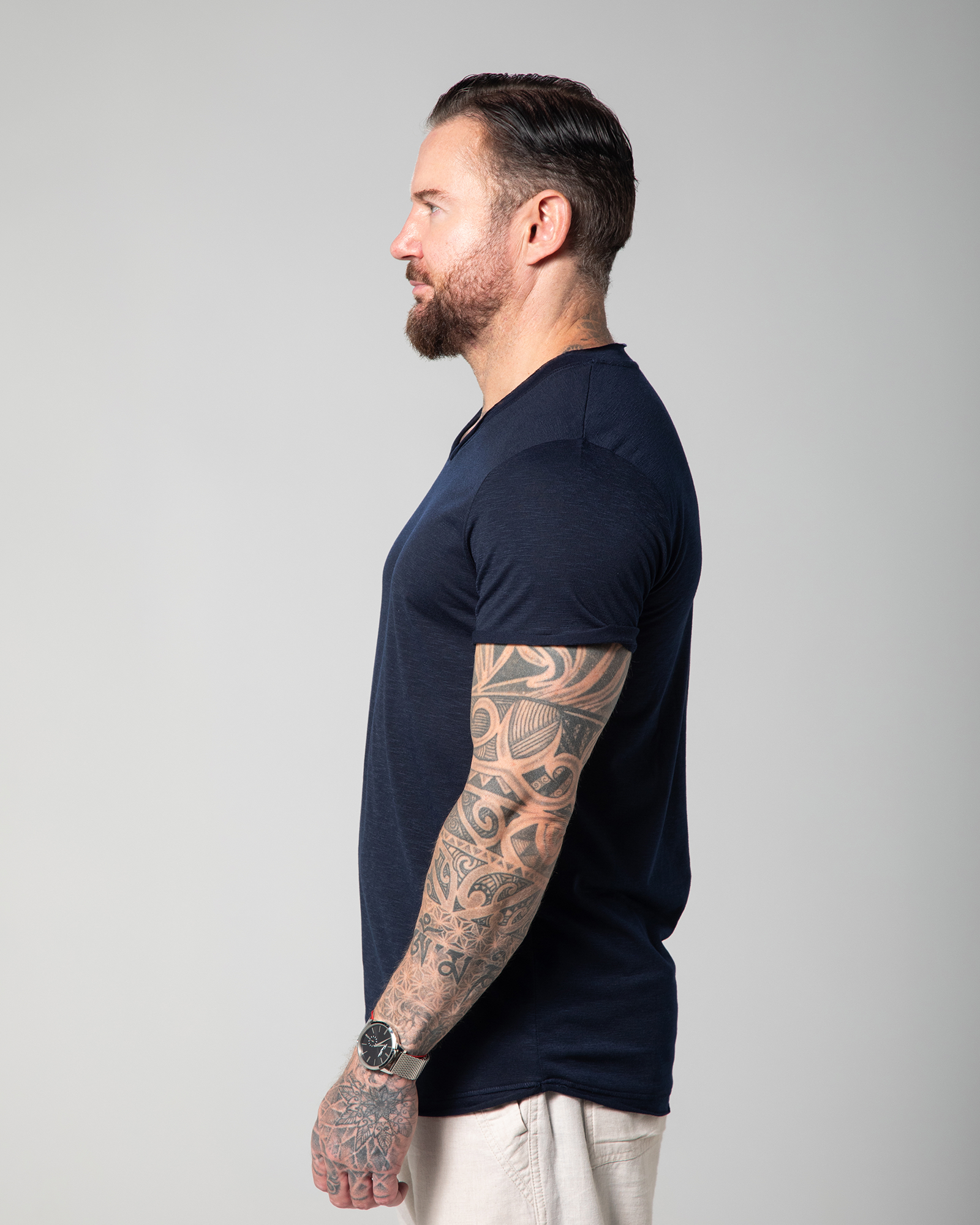 Side angle of the Marbella V-neck T-shirt in blue, highlighting the relaxed sleeve fit, curved hem, and breathable slub texture perfect for warmer days UAE KSA Qatar