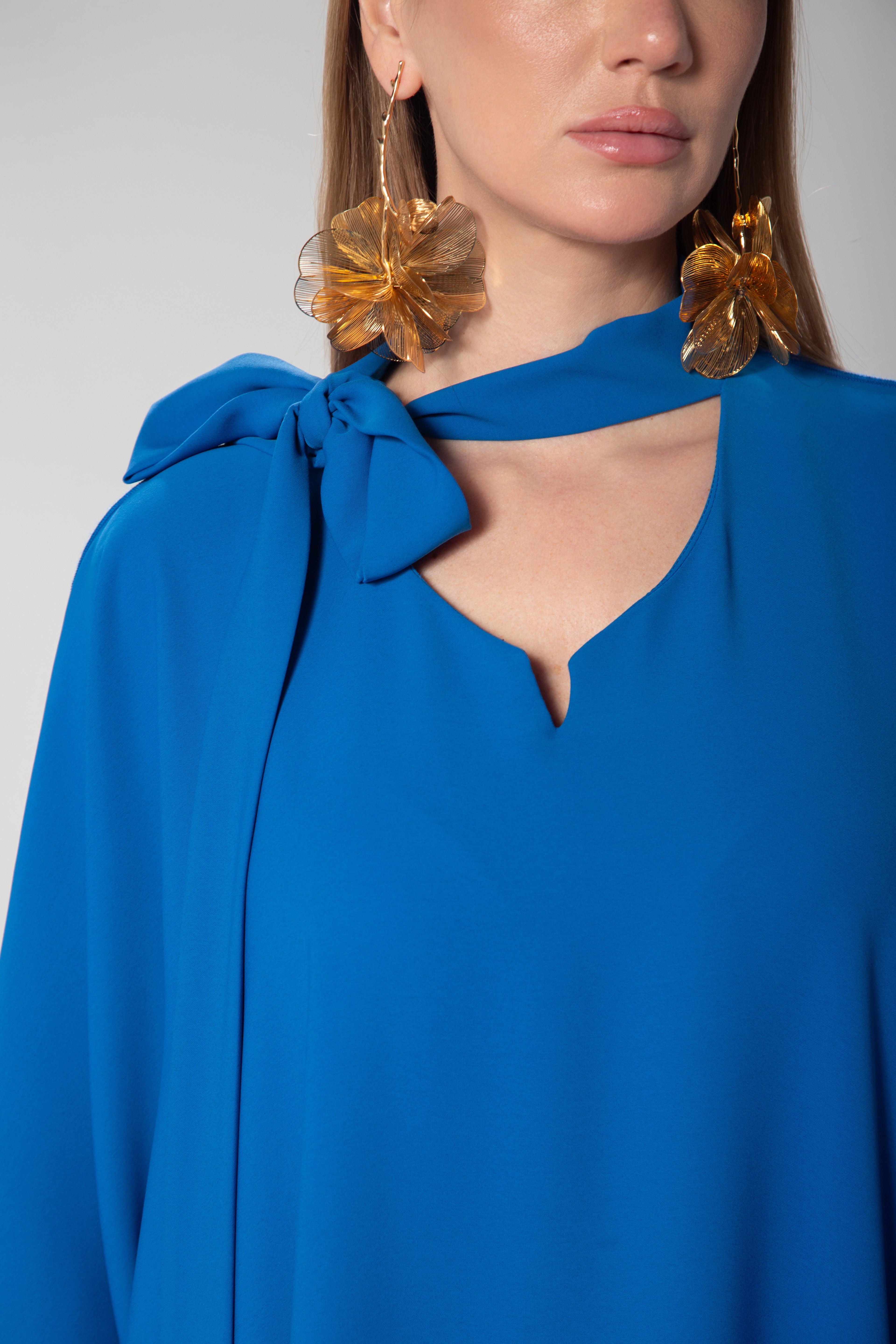 Detailed neckline with elegant side bow on royal blue kaftan dress by Omni The Label perfect for elevated modest looks across UAE Qatar KSA