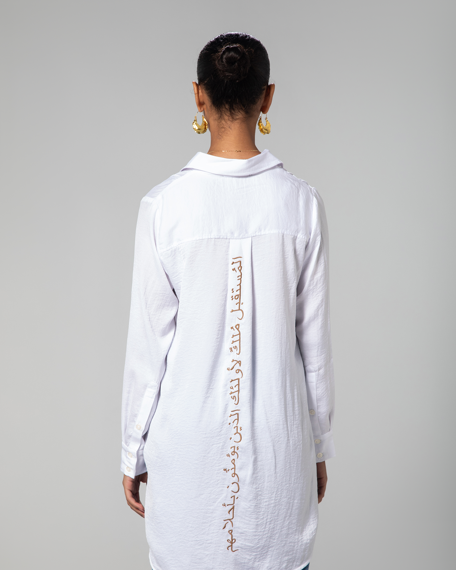 Angled view showcasing Arabic calligraphy embroidery on the back of Omni The Label shirt cultural fusion loved in Qatar UAE and KSA