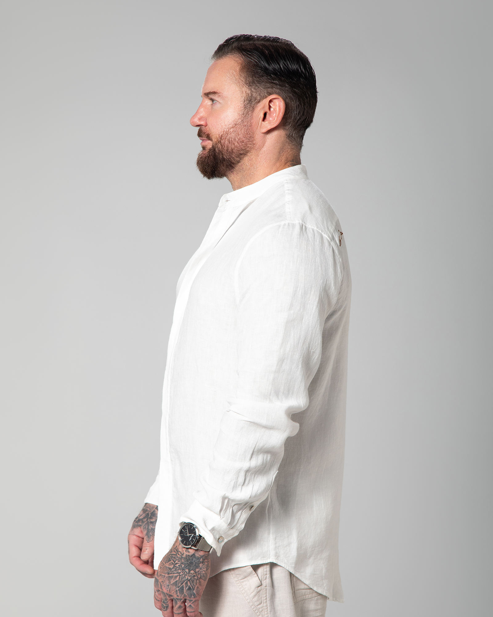 Side view of model wearing Omni The Label’s St. Tropez Linen Shirt in white – UAE, KSA, Qatar