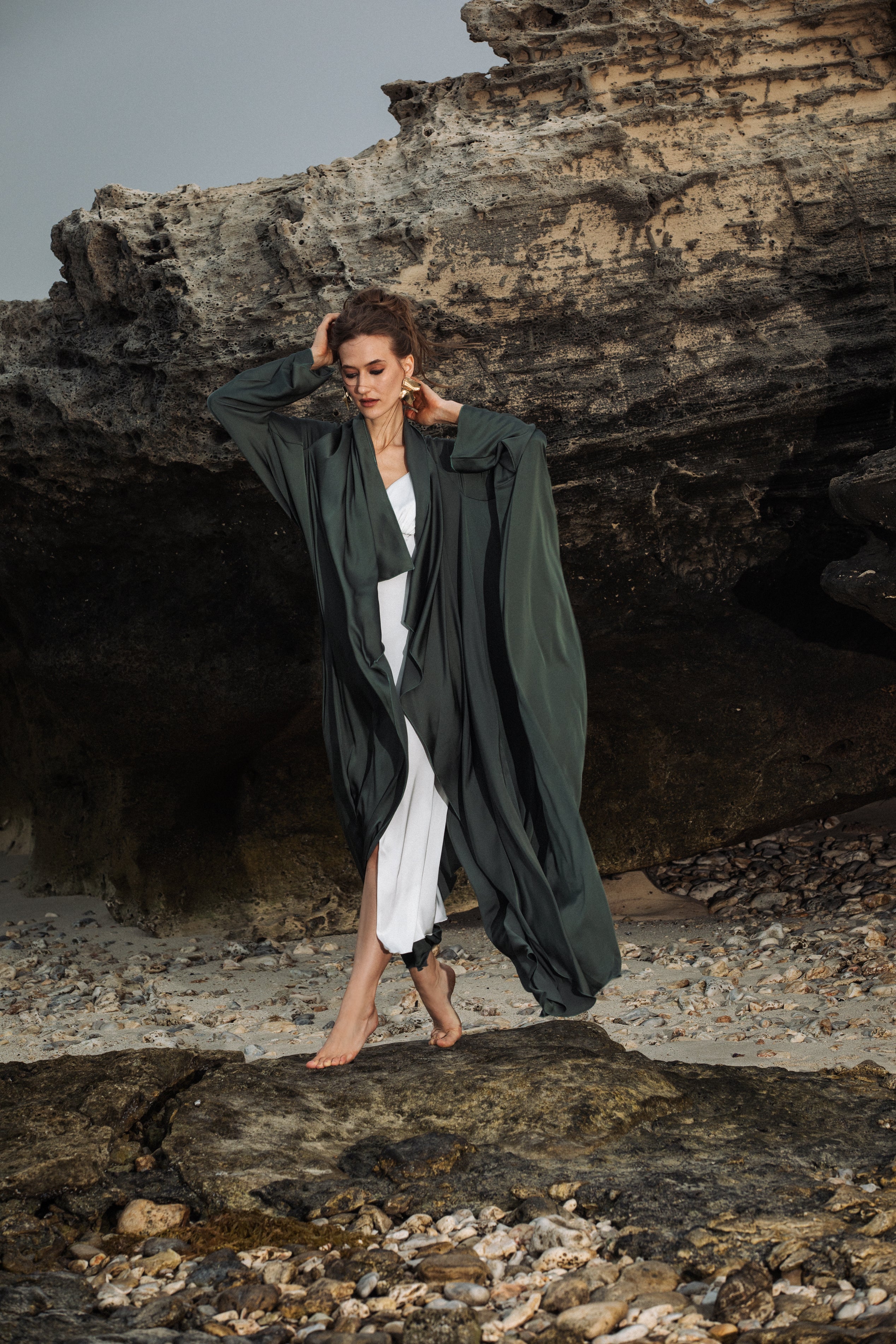 Omni The Label’s green Flow Abaya layered over white outfit, styled open – UAE, KSA, Qatar