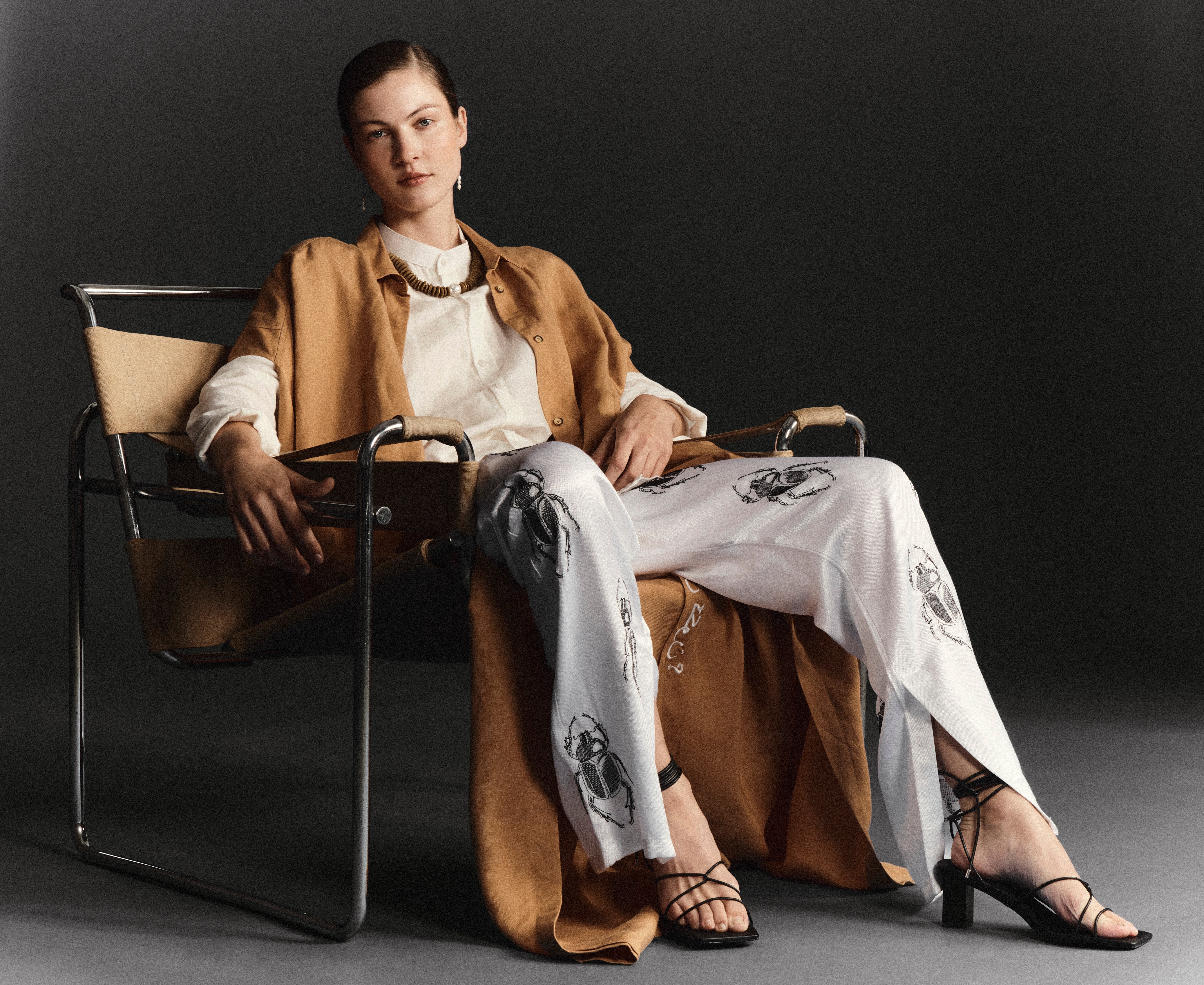 Elegant camel brown kaftan from Omni The Label styled in a luxurious setting Qatar UAE KSA fashion inspiration