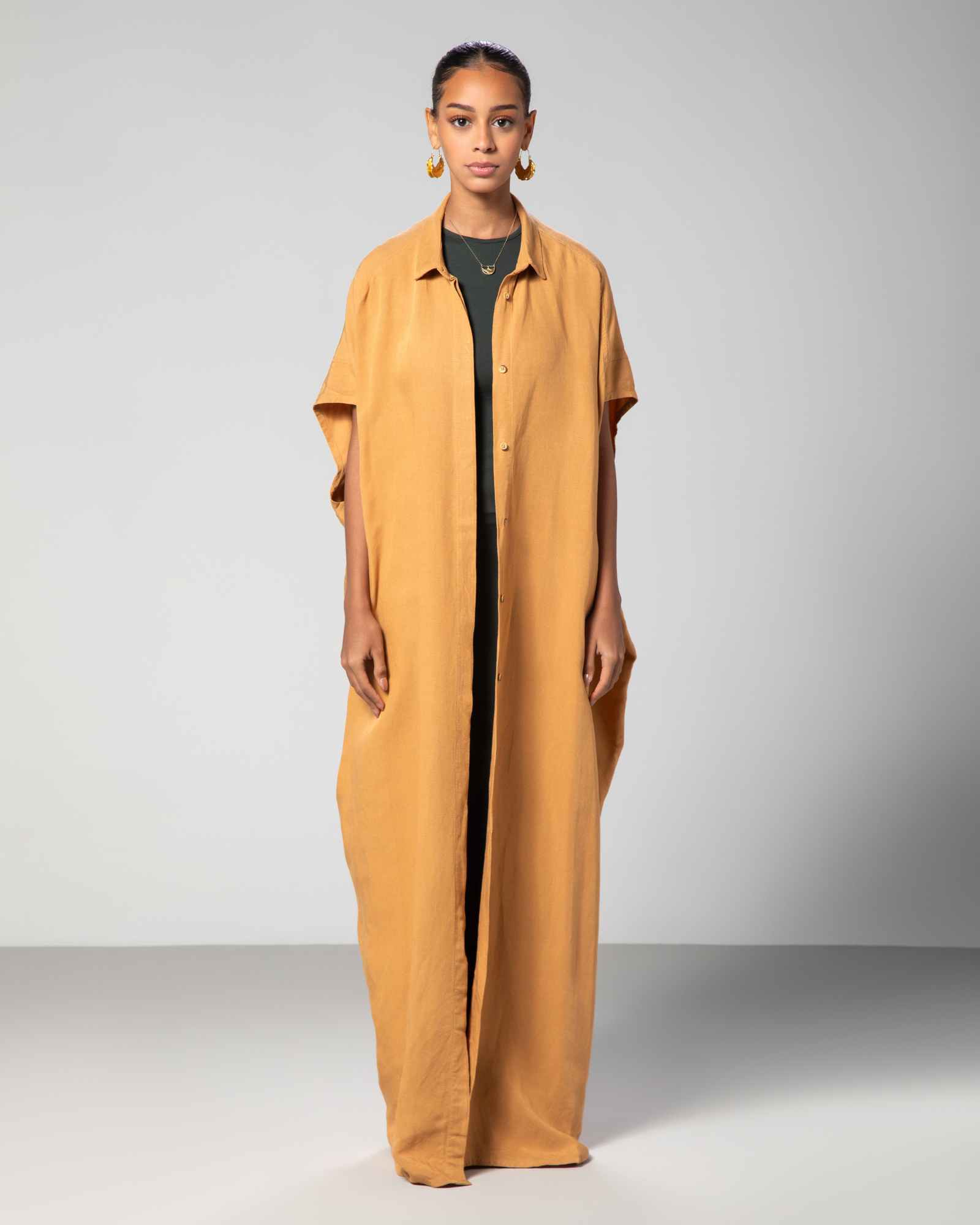 Front view of camel brown kaftan from Omni The Label featuring clean lines and relaxed silhouette perfect for Qatar UAE KSA wardrobes