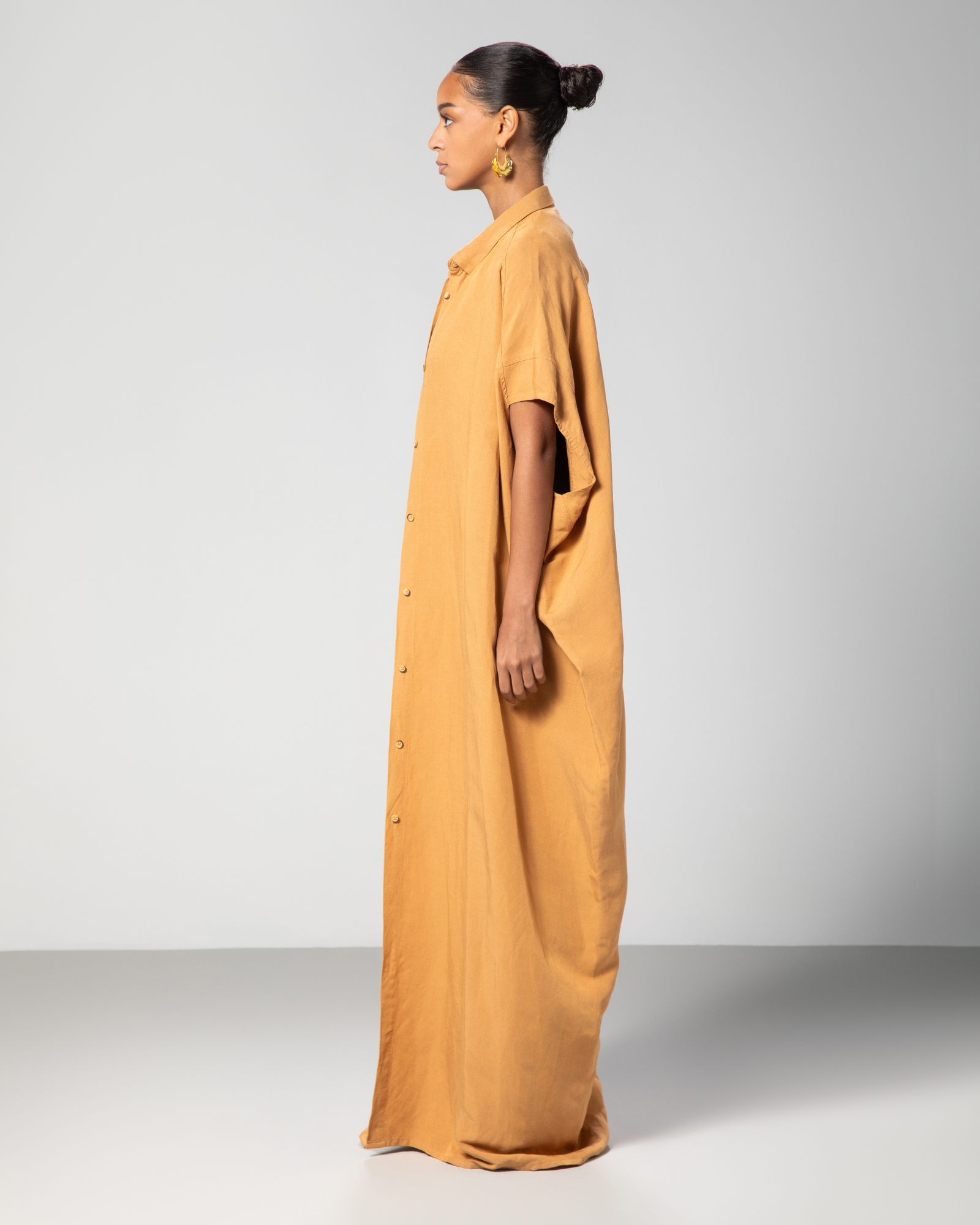 Side angle of Omni The Label camel kaftan loose silhouette UAE KSA Qatar
