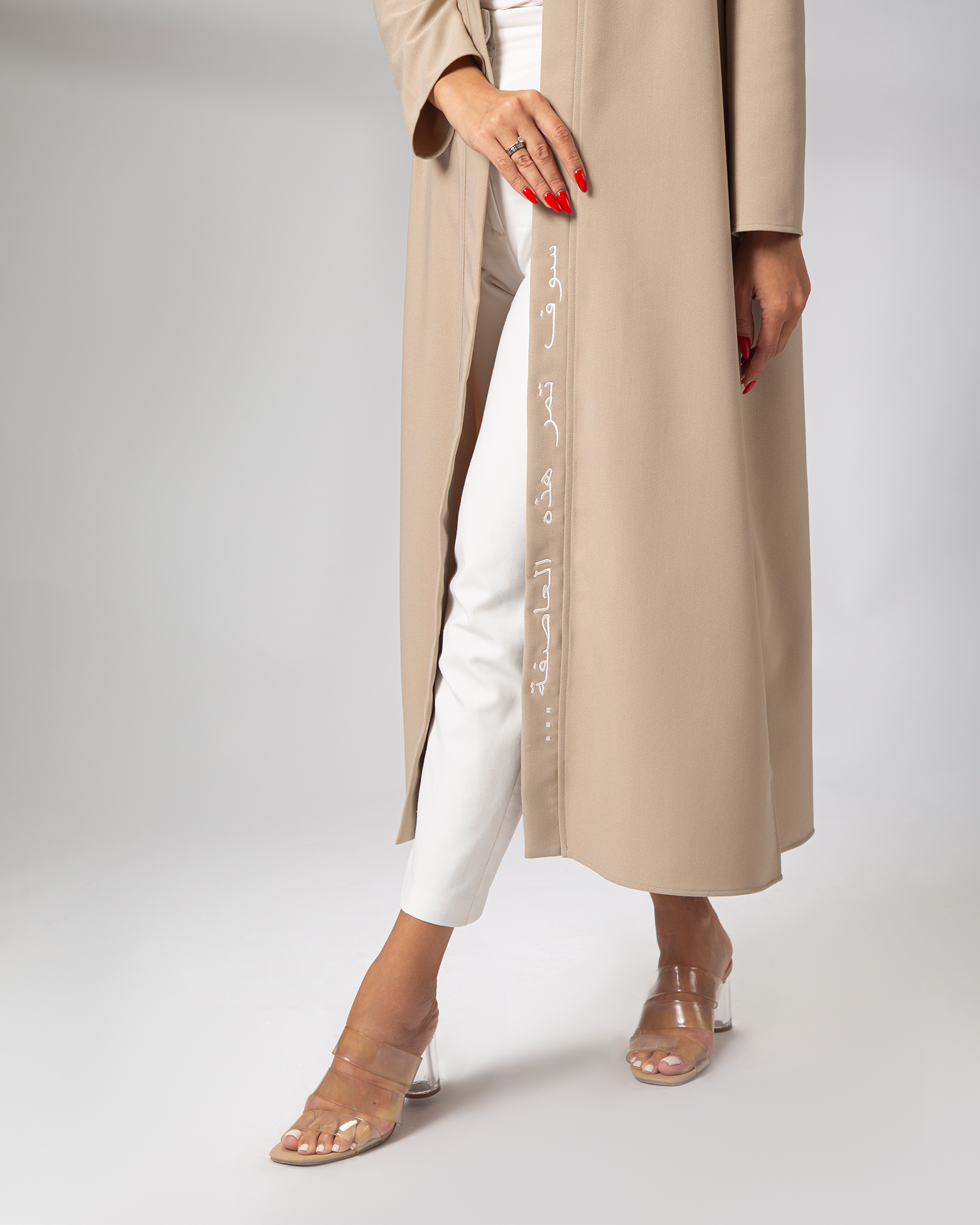 Side profile of nude kimono in motion, featuring Arabic calligraphy embroidery uae ksa qatar