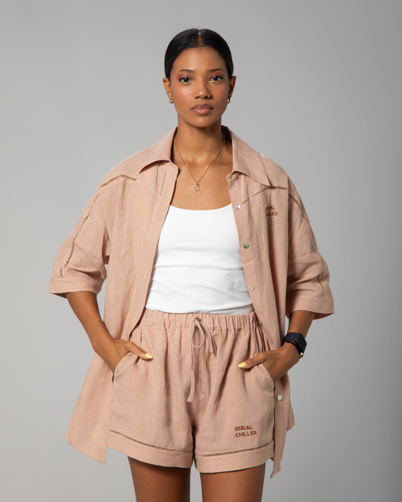Neutral-toned linen co-ord from Omni The Label with polished mother-of-pearl button closure, blending luxury detail with everyday comfort UAE KSA Qatar
