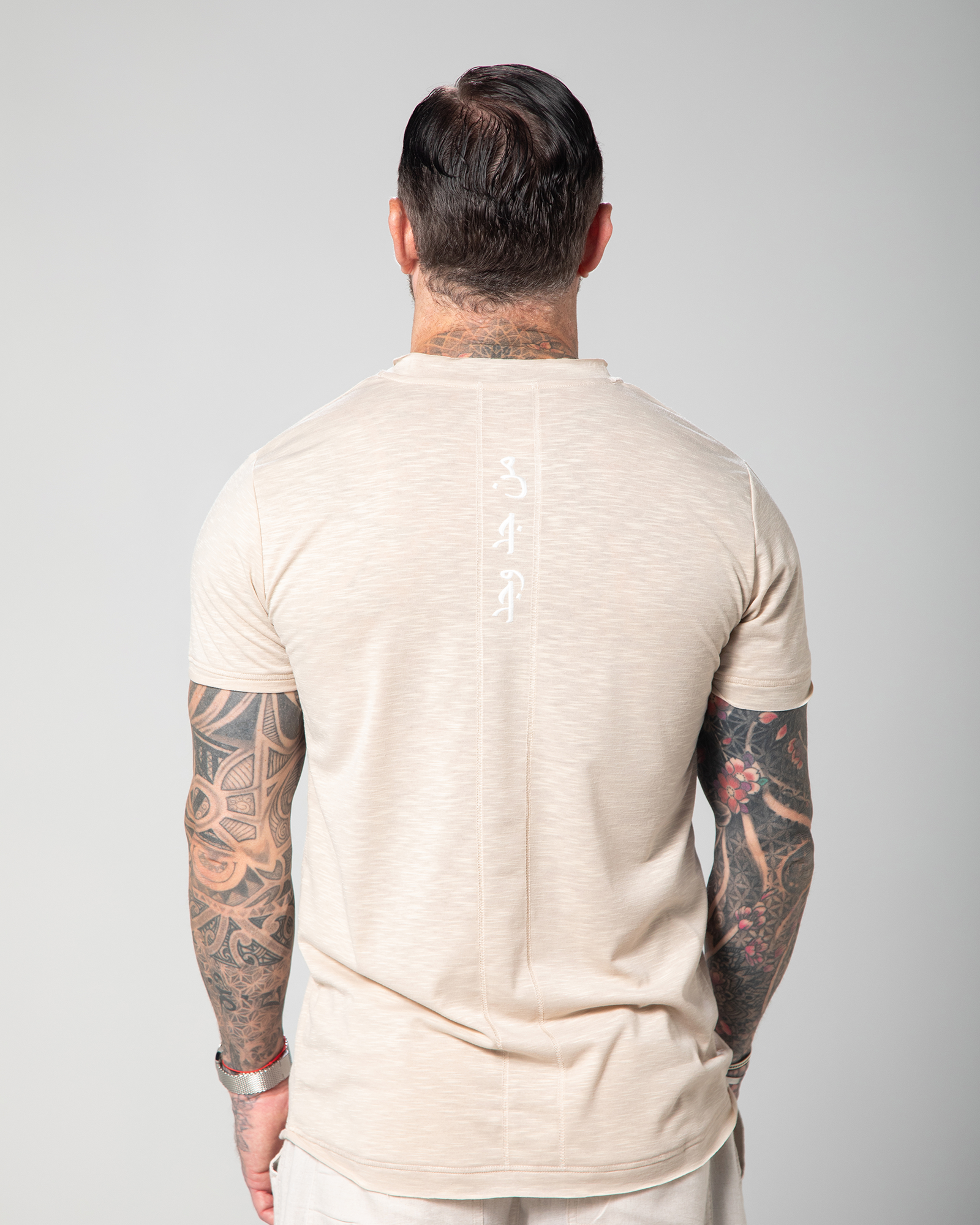 Back view of the Marbella T-shirt in nude, featuring Arabic embroidery UAE KSA Qatar