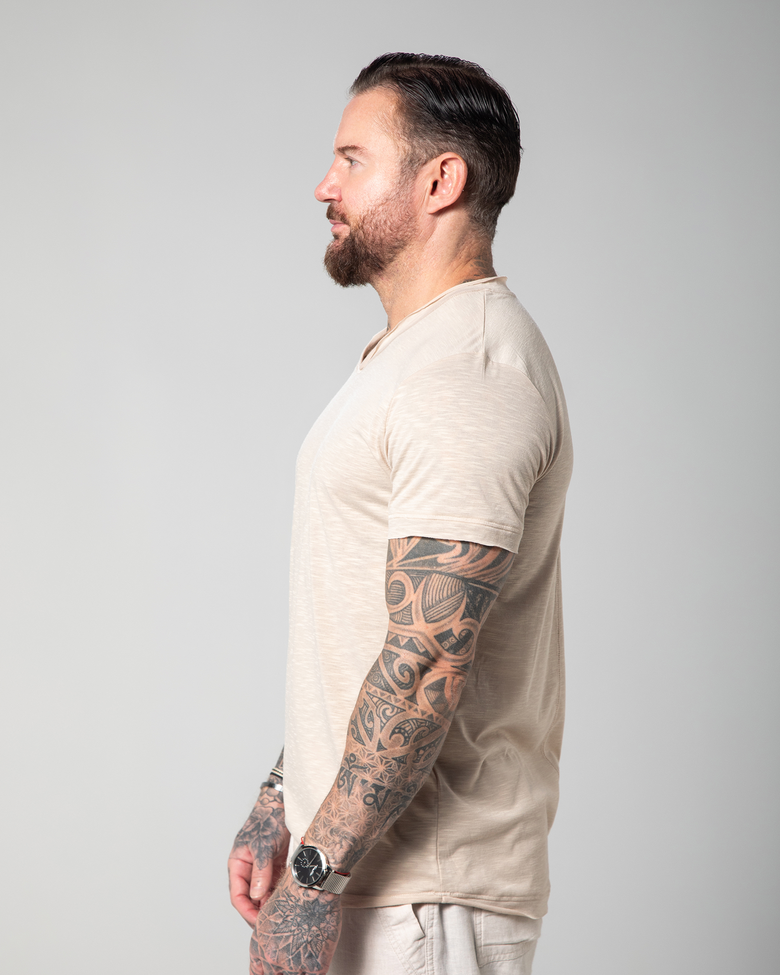 Side view of the Marbella nude T-shirt worn by male model, revealing the relaxed fit, short sleeves, and breathable construction—ideal for everyday wear with depth and character UAE KSA Qatar