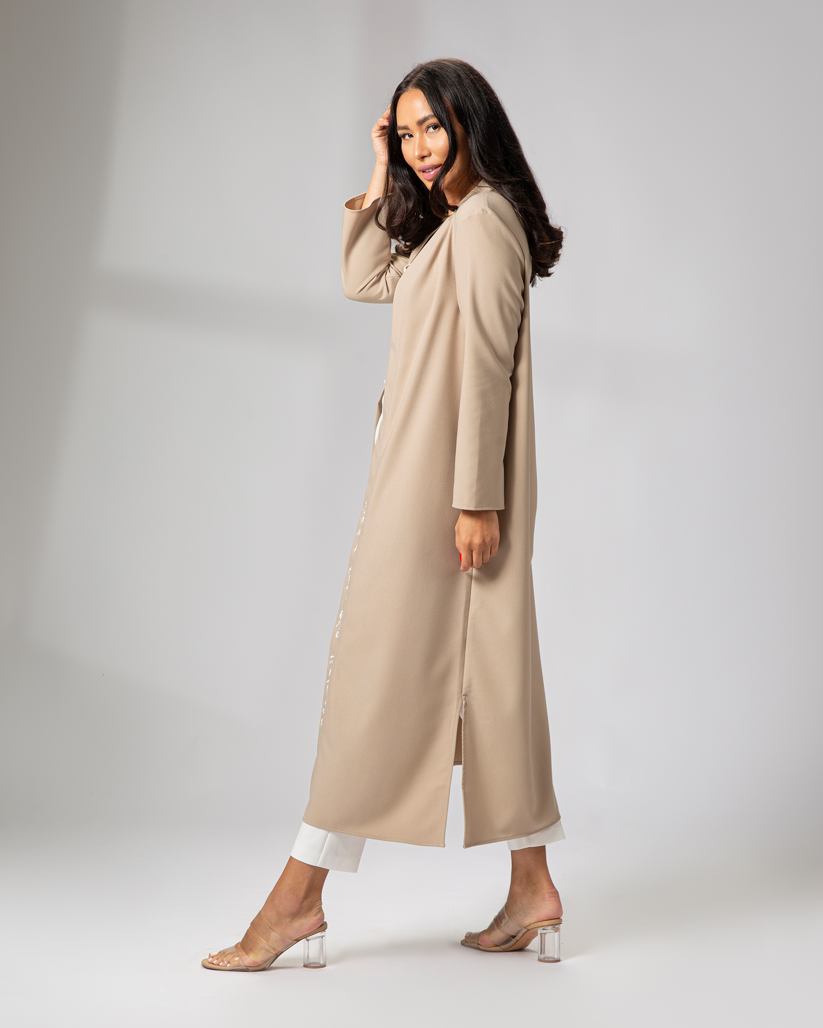 Side profile of nude kimono in motion, featuring Arabic calligraphy embroidery uae ksa qatar