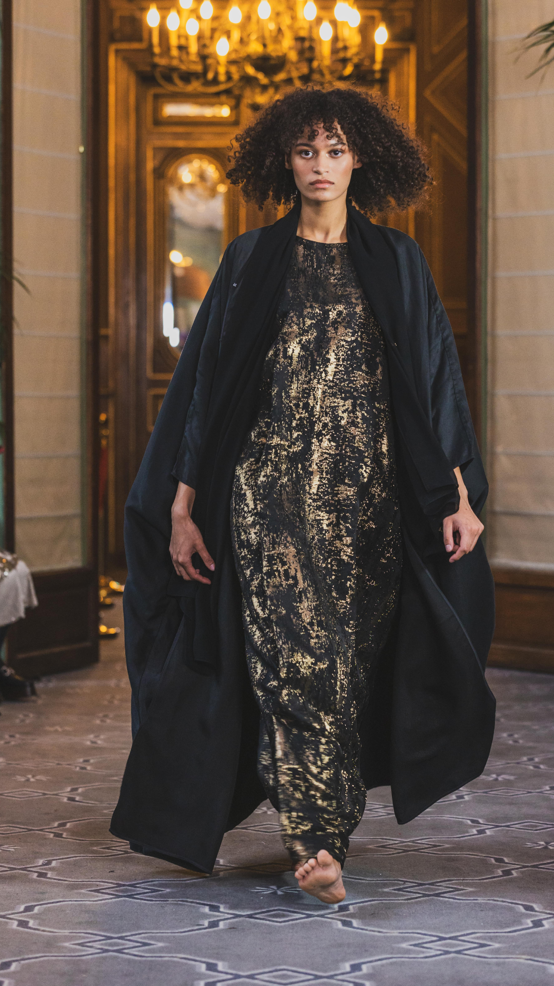 runaway from paris fashion week of abayas, a black abaya with arabic caligraphy embroidered on the back by omni the label