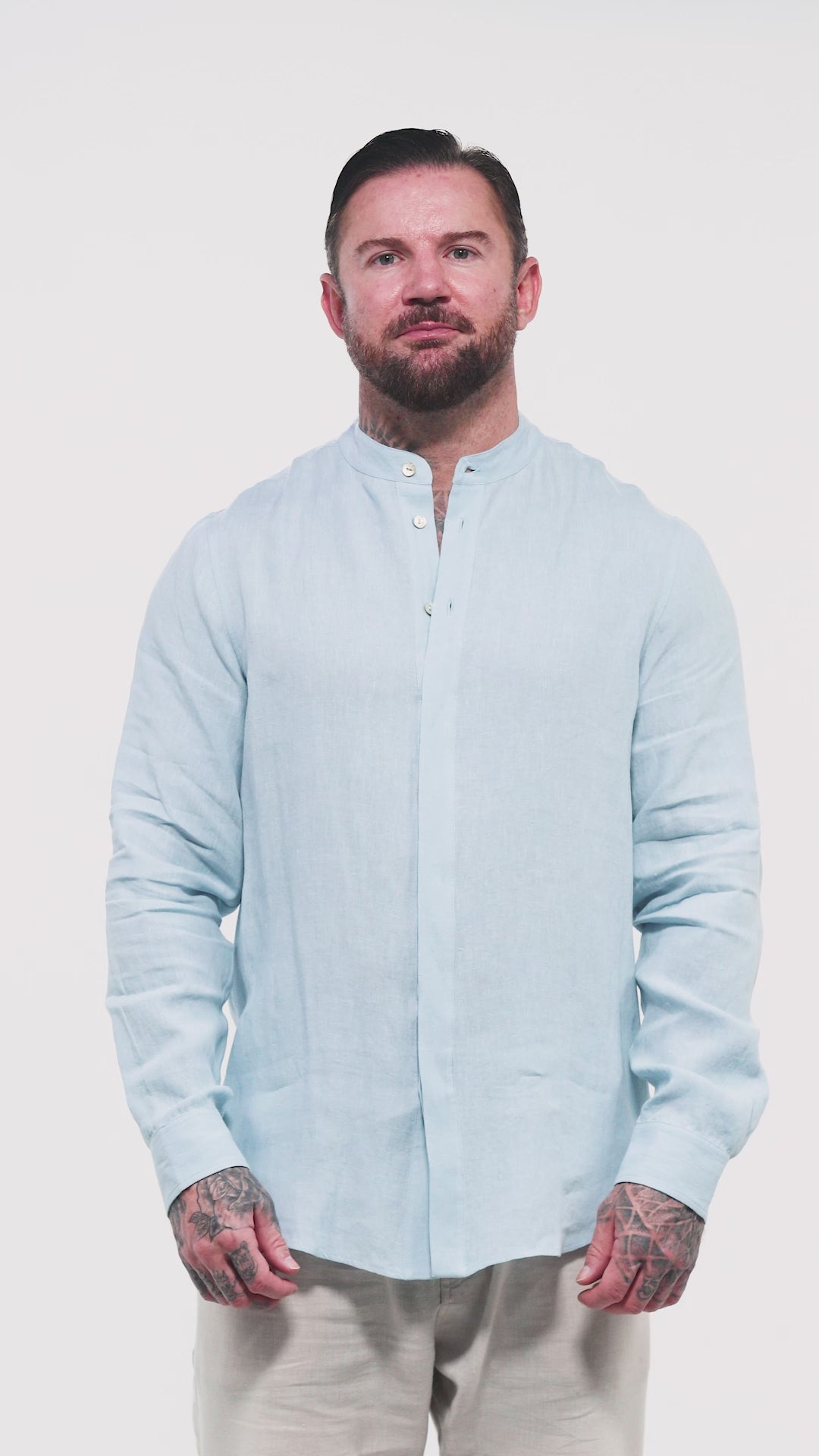 Video of male model wearing light blue St. Tropez linen shirt with Arabic calligraphy on the back KSA UAE Qatar