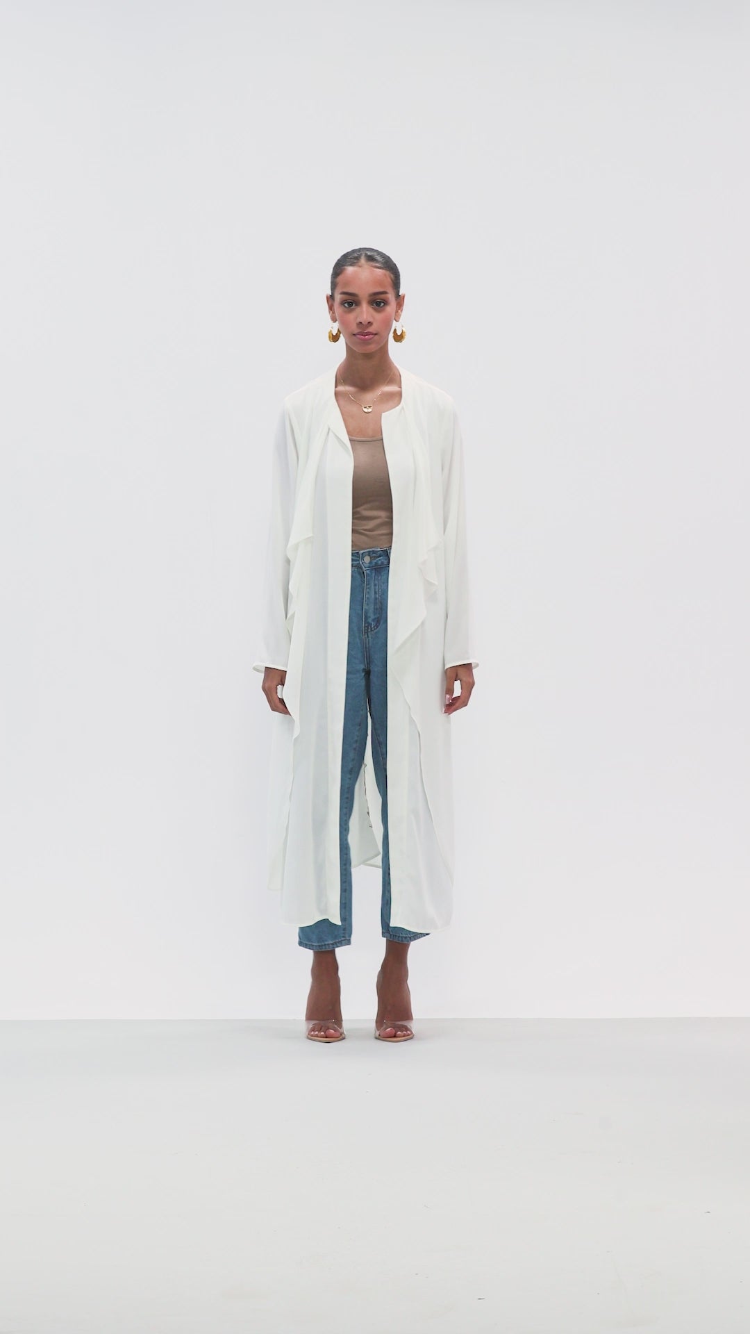 video Full-length front view of The 4pm Cover Up in White styled with jeans