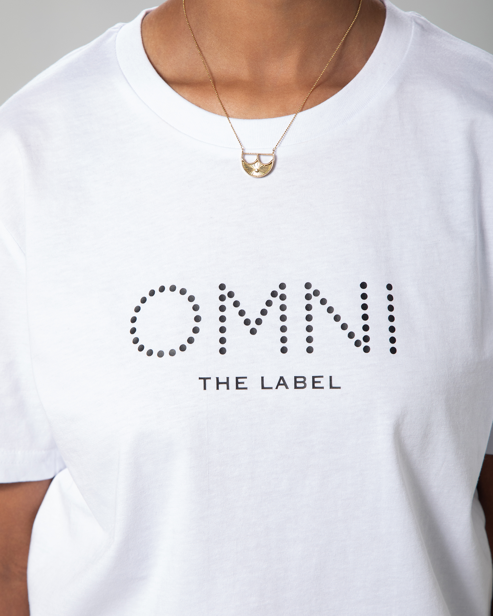 Zoomed-in view of print detail on white T-shirt from Omni The Label, celebrating cultural identity through fashion.KSA UAE Qatar