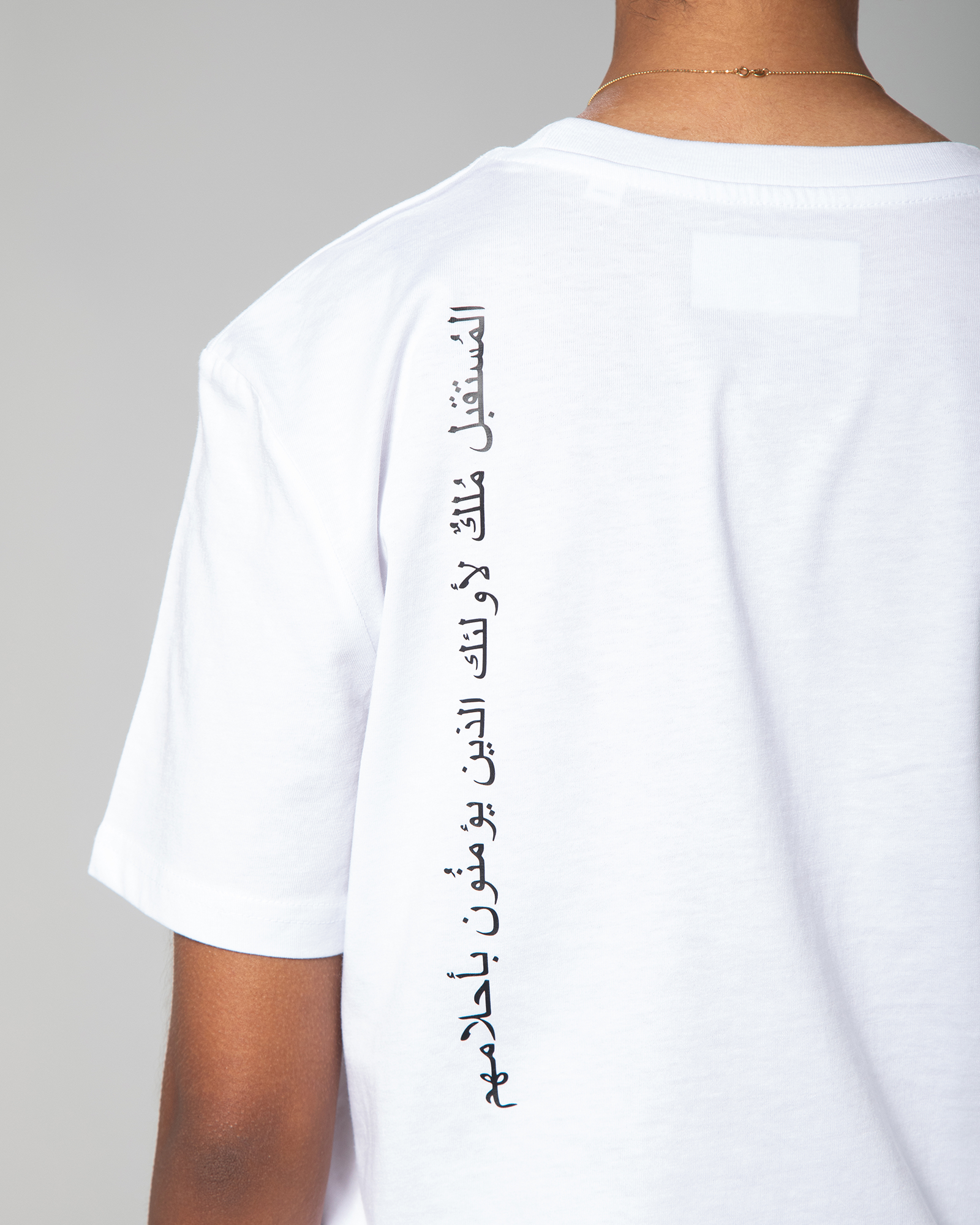 Full Arabic calligraphy printed vertically on back of white T-shirt by Omni The Label UAE KSA Qatar