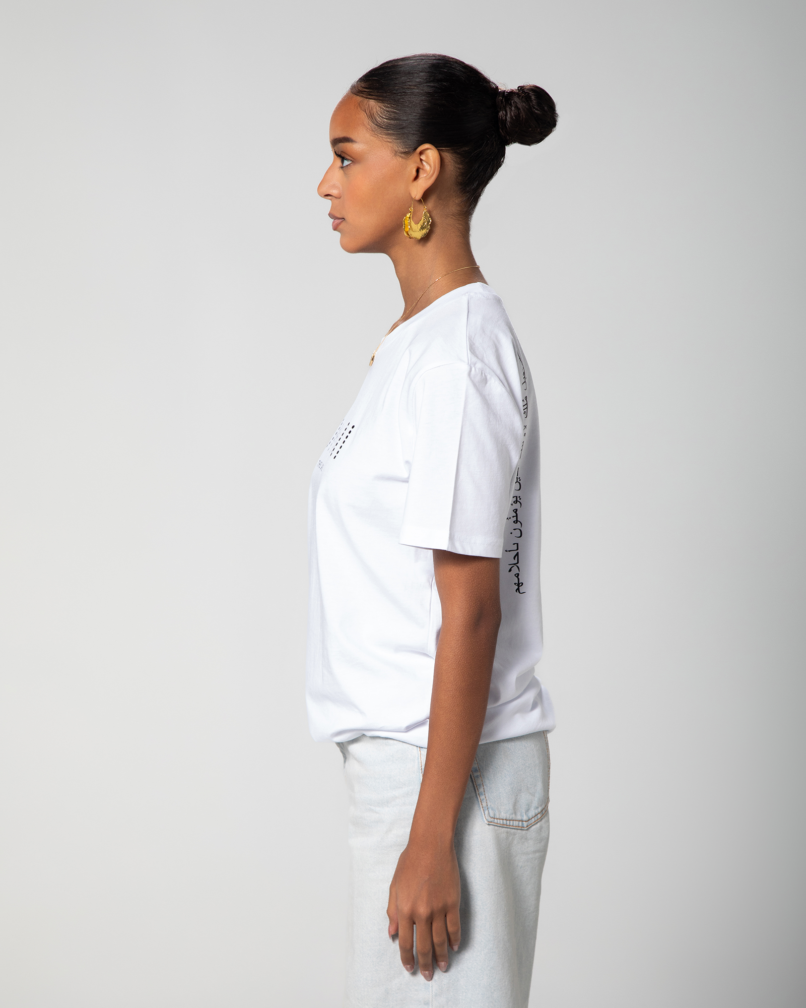 Side profile of white T-shirt featuring Arabic calligraphy on the back KSA, UAE, Qatar