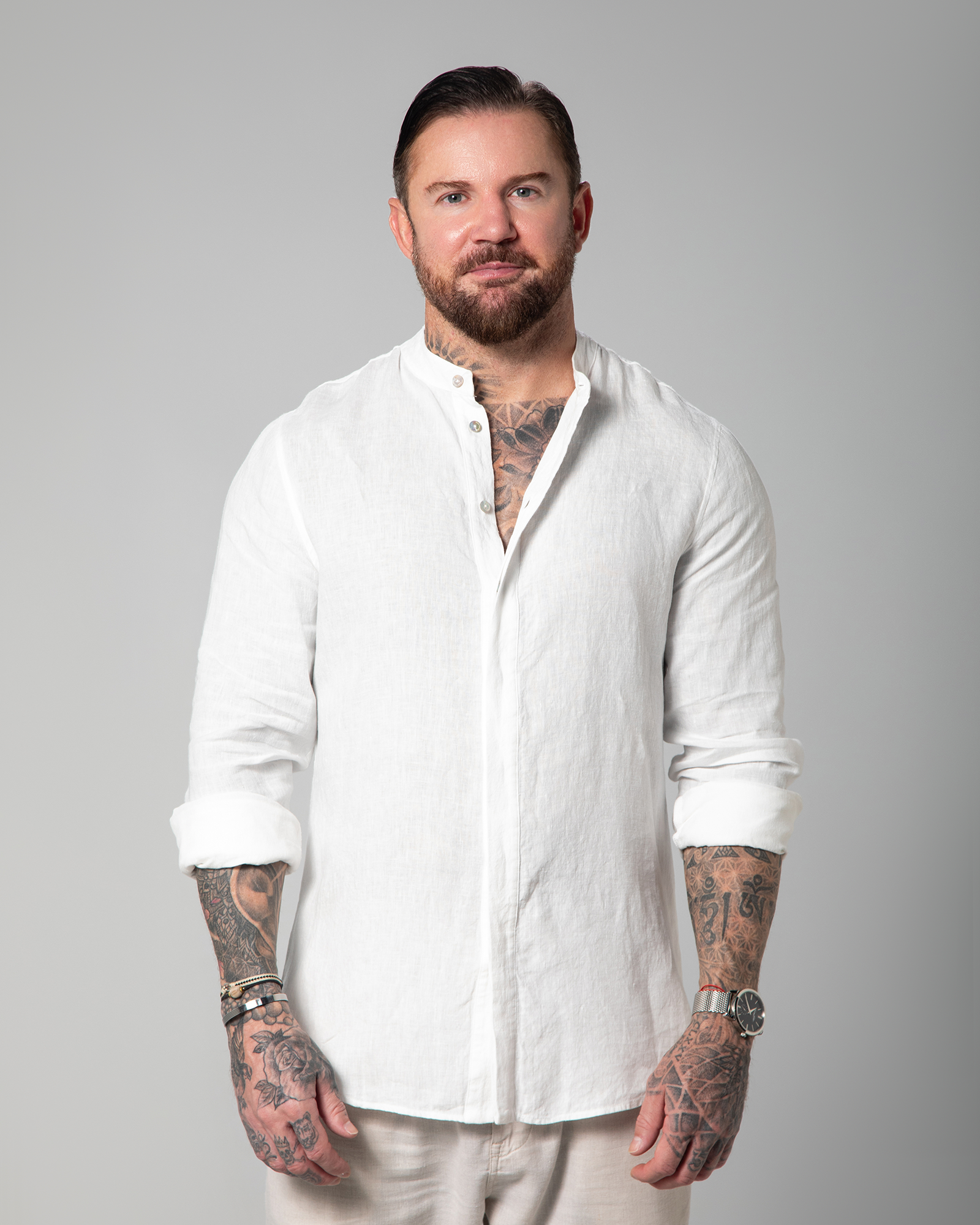 Model styling the white linen shirt open over white tank top by Omni The Label – UAE, KSA, Qatar