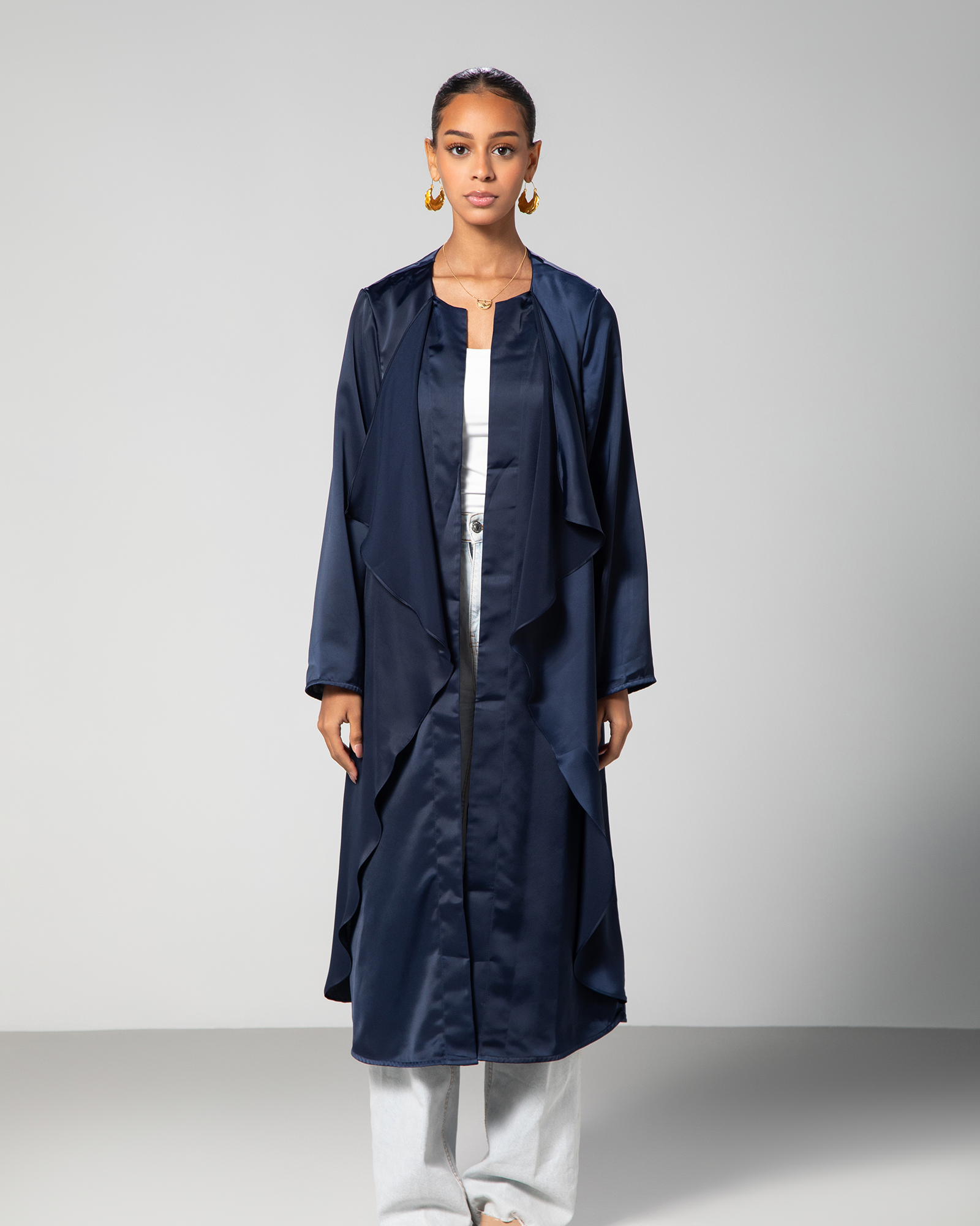 Full front view of model wearing the navy blue open-front cover-up with clean, minimal layering over white separates KSA UAE Qatar