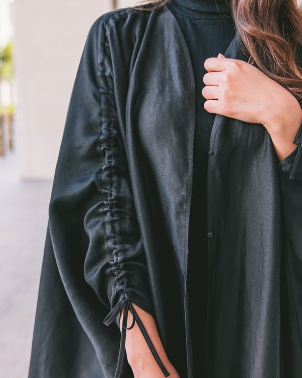 Close-up of adjustable sleeve detail on black abaya with tie feature Omni The Label KSA UAE Qatar