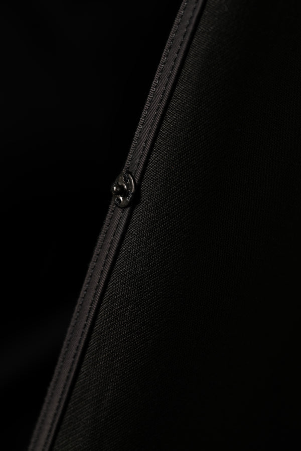 Zoomed view of front snap button on black abaya linen blend fabric Omni The Label UAE KSA Qatar