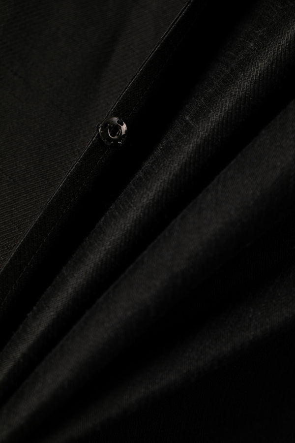 Close up of black fabric texture with snap button Omni The Label detail shot Qatar UAE KSA