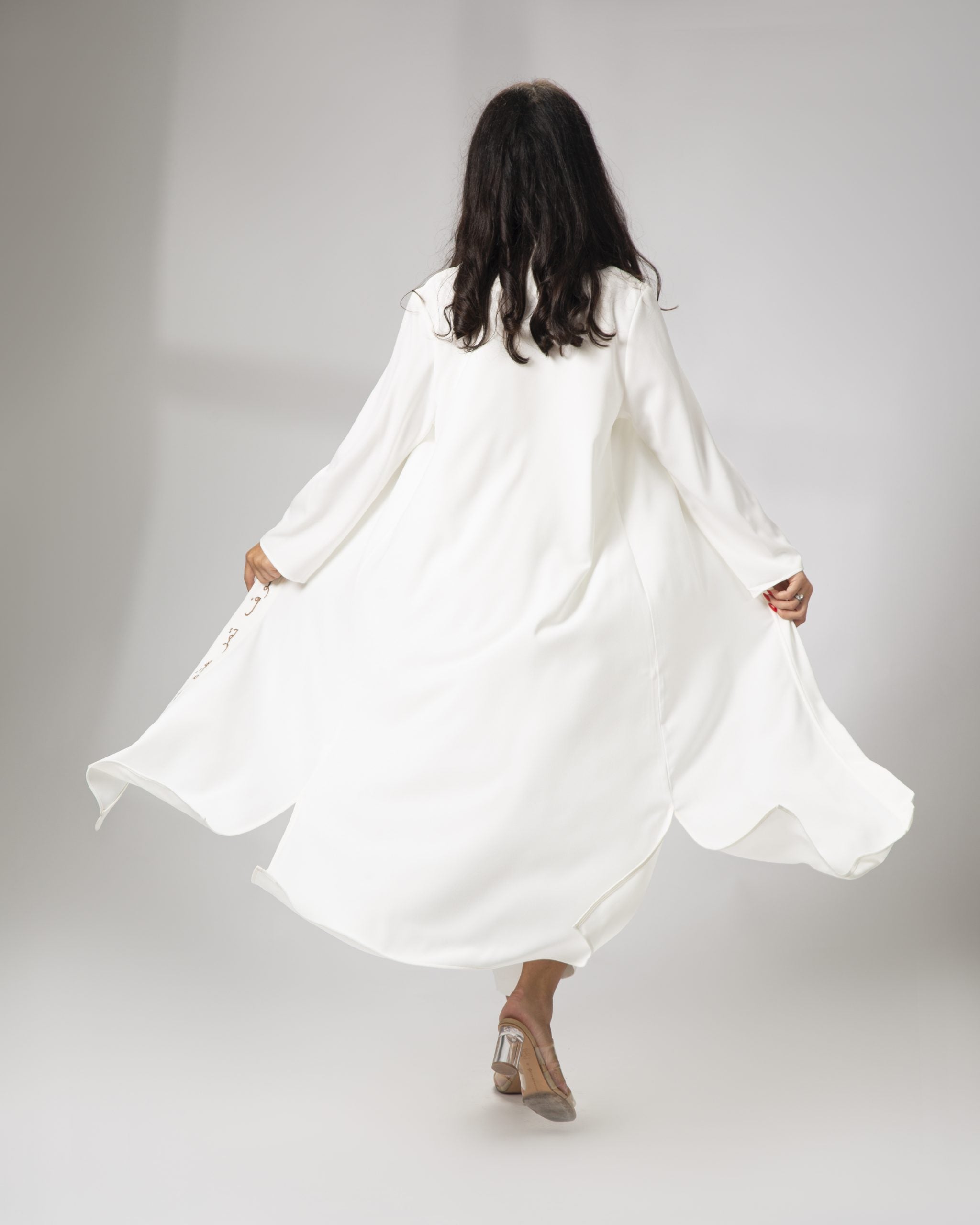 Flowing white kimono in motion back view modern modest fashion by Omni The Label worn in Qatar UAE KSA