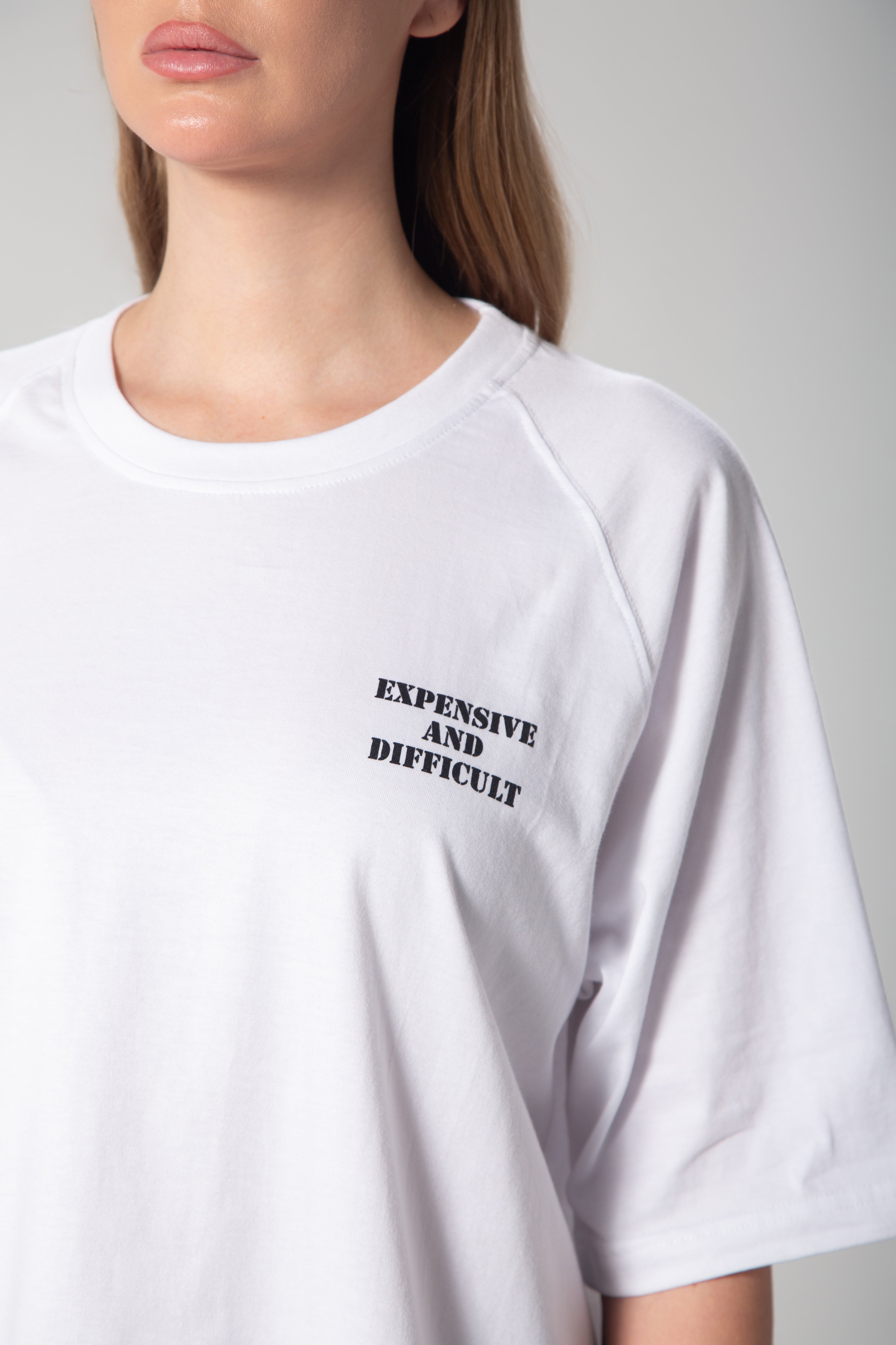 Oversized t-shirt featuring the phrase "Expensive & Difficult" in bold lettering. Designed for a relaxed fit, making it a statement piece for effortless, confident styling.