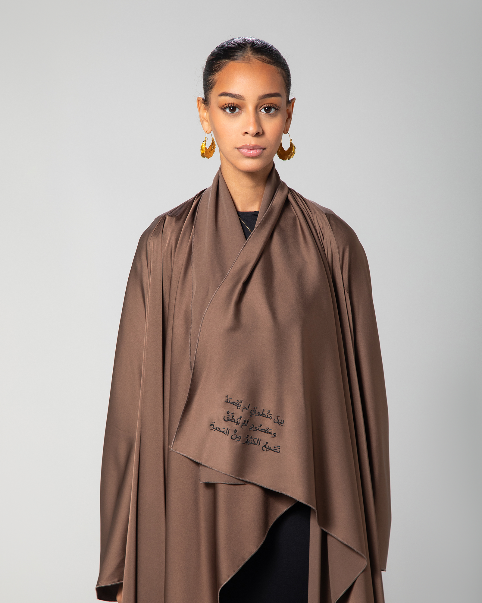 Model wearing the Flow Abaya  modest coverage with a minimalist, culturally inspired silhouette KSA UAE Qatar

