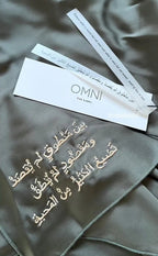 Detailed embroidery shot from Omni The Label’s Flow Abaya featuring Arabic text – UAE, KSA, Qatar