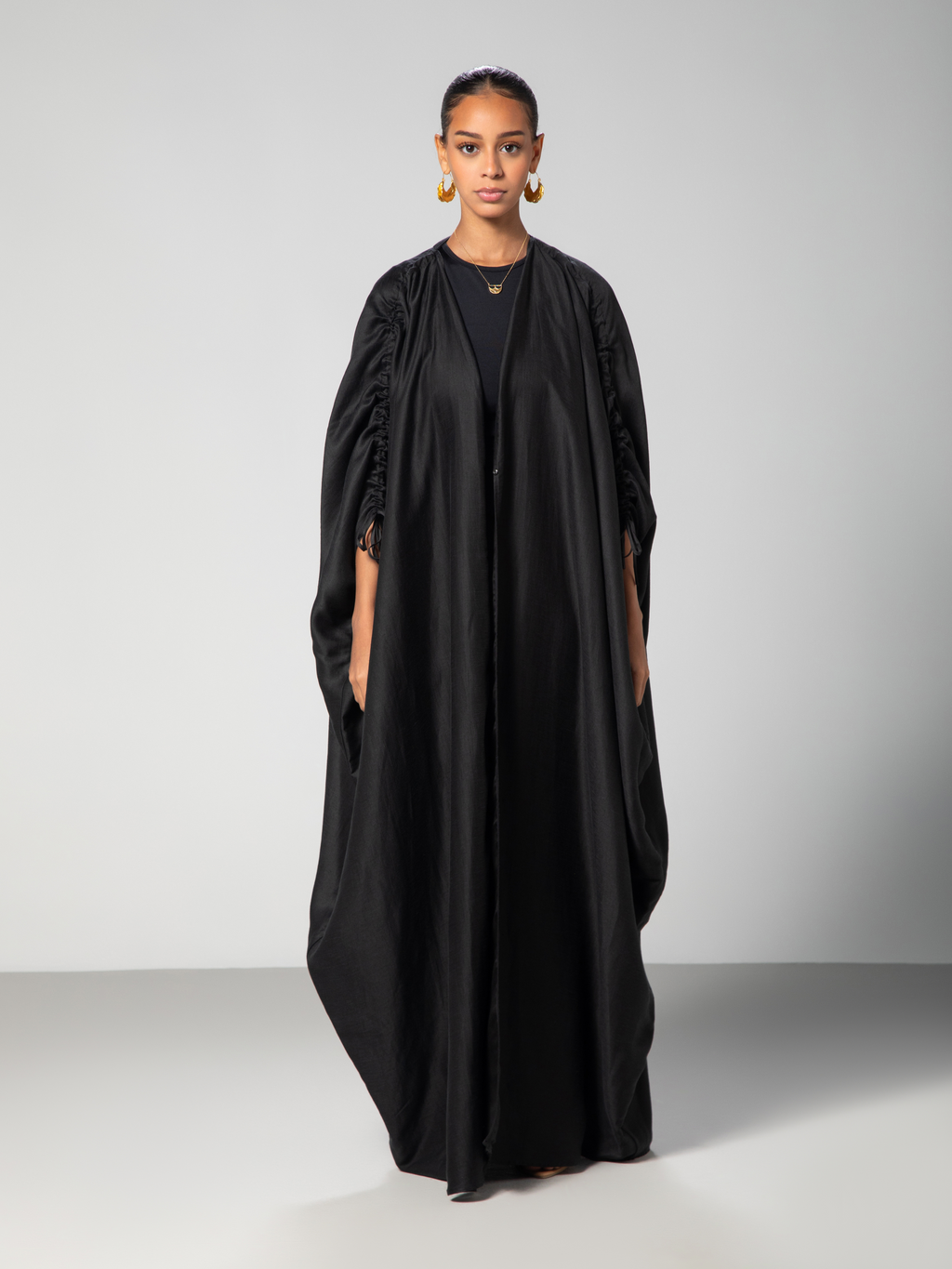 Full lenghtBlack abaya with adjustable sleeves Arabic calligraphy embroidery on the back studio Omni The Label UAE KSA Qatar

