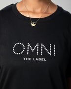 etailed front view of the black T-shirt showing Omni The Label logo printed across the chest in minimalist white font.
