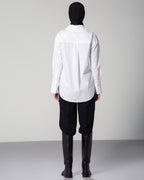 Minimalist white cotton poplin shirt for women – OMNI The Label fashion piece styled with black hijab on gray backdrop ksa Qatar