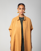 Close-up showing collar and front detail of camel brown kaftan by Omni The Label Qatar UAE KSA