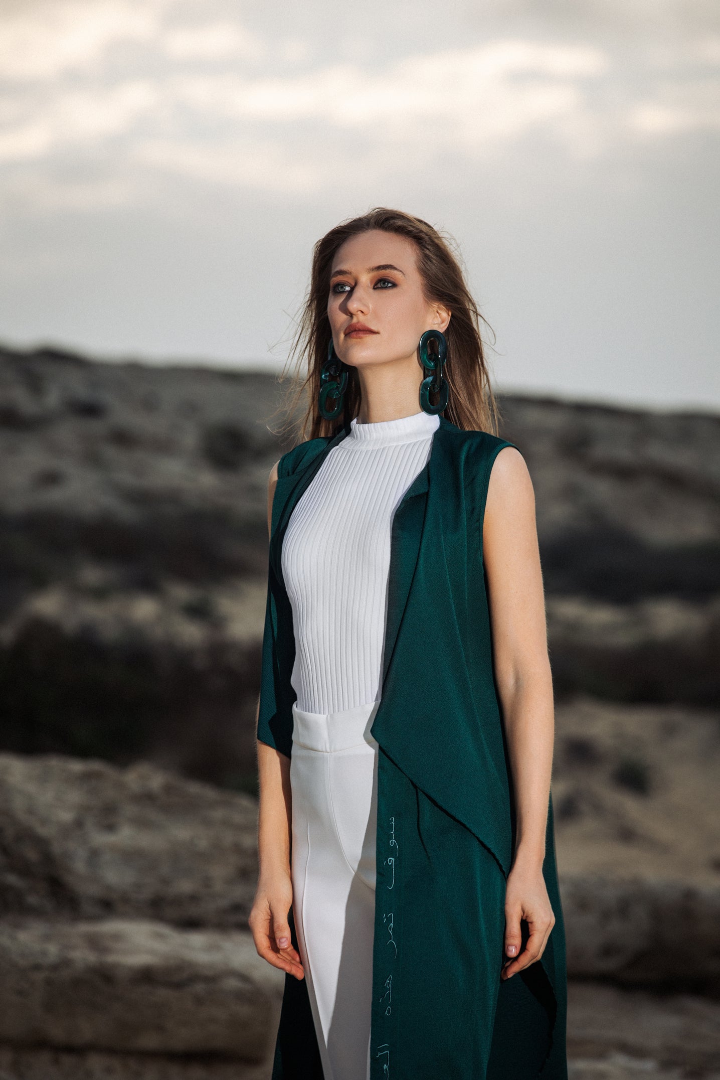 Smiling model wearing green cover-up with visible embroidery detail UAE, KSA, Qatar