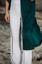Detailed shot of green fabric and Arabic quote print on sleeveless cover-up – UAE, KSA, Qatar
