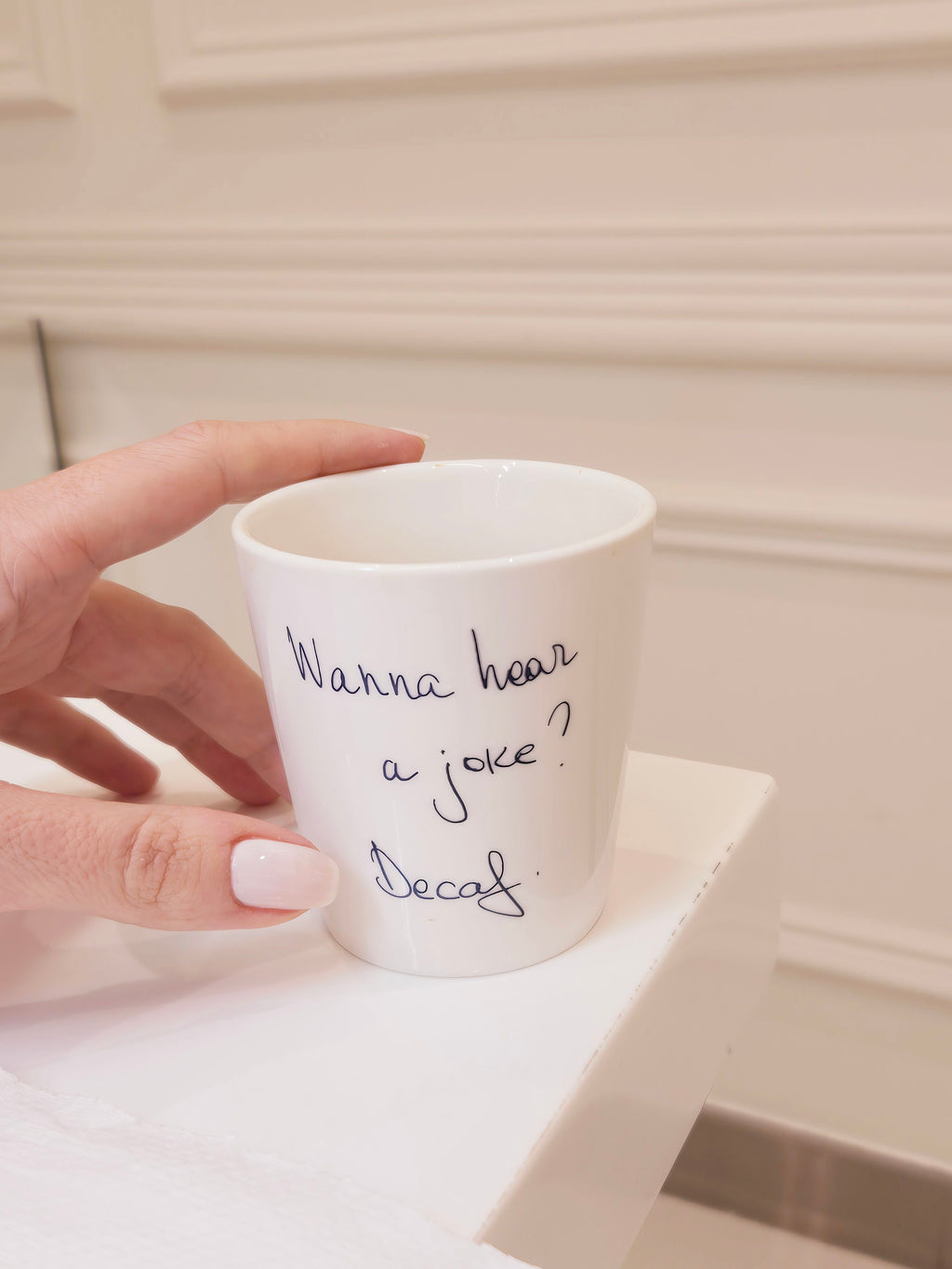 A white  coffee cup with the text 'Wanna hear a joke? Decaf' written on it, KSA UAE Qatar