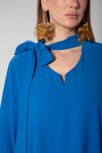 Detailed neckline with elegant side bow on royal blue kaftan dress by Omni The Label perfect for elevated modest looks across UAE Qatar KSA