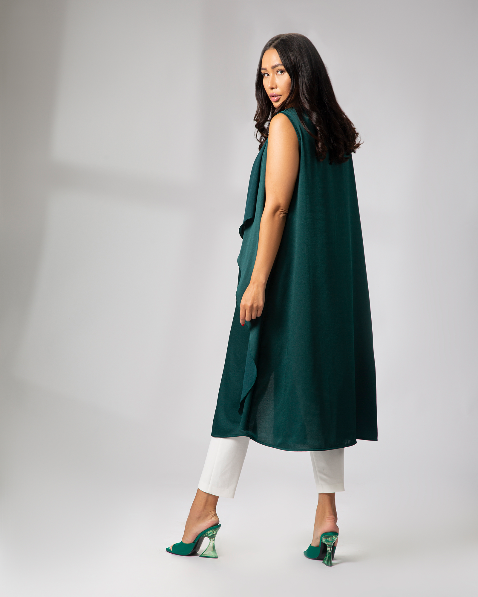 Side view of green sleeveless cover-up in motion, flowing silhouette with front opening – UAE, KSA, Qatar
