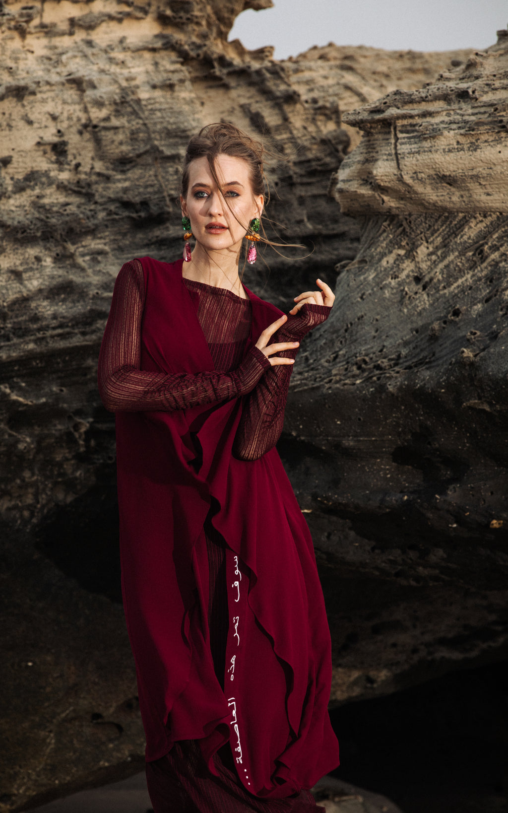 Woman wearing Omni The Label burgundy cover up  timeless modest style  KSA UAE Qatar
