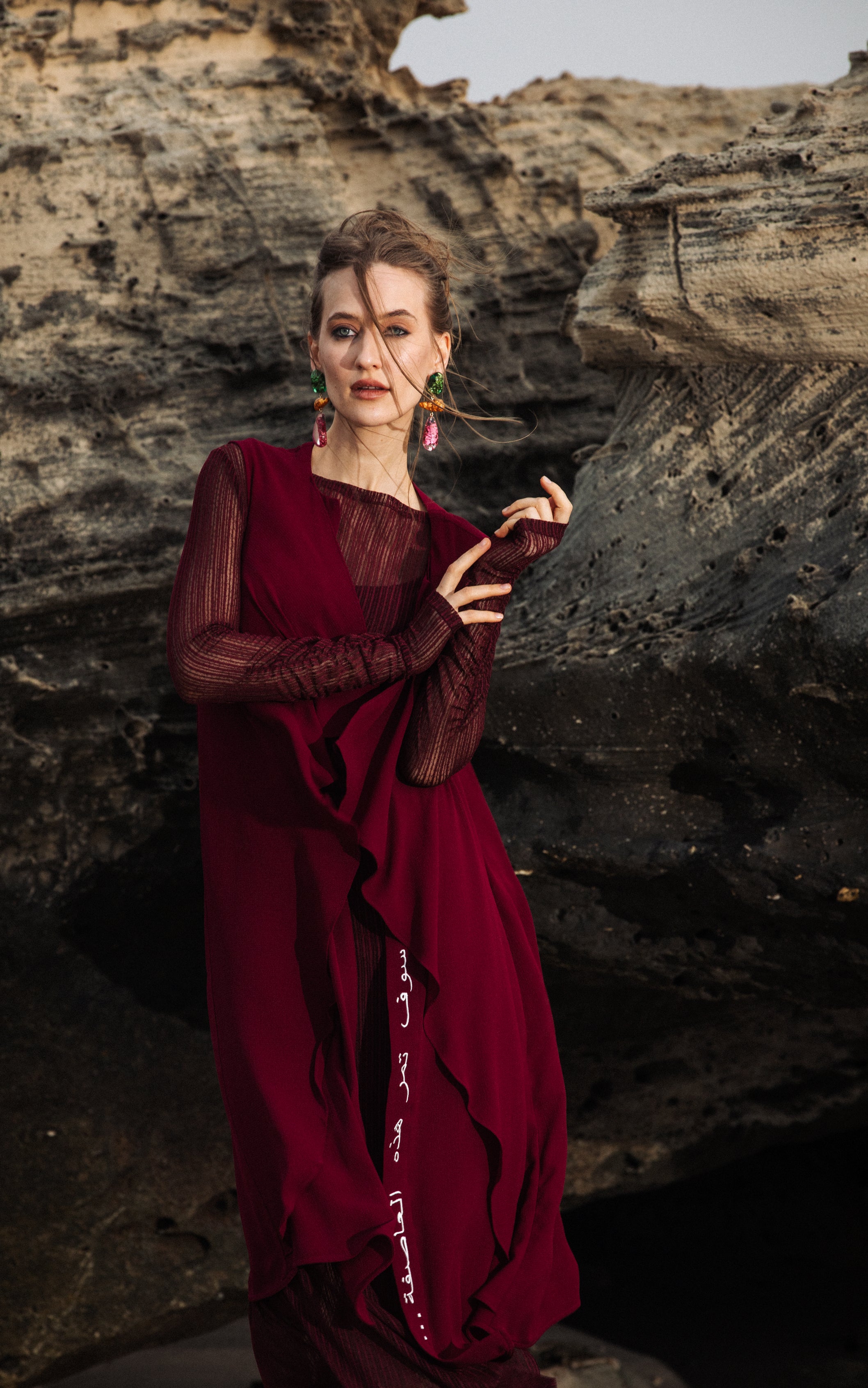 Woman wearing Omni The Label burgundy cover up  timeless modest style  KSA UAE Qatar
