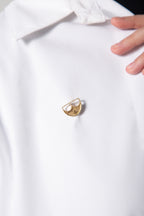 Close-up of The Batoolah Brooch 18K Gold styled on a white shirt, showcasing the 18K solid gold finish and its elegant cultural silhouette KSA UAE Qatar