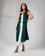 Model in sleeveless green cover-up with Arabic embroidery, styled over white outfit UAE, KSA, Qatar