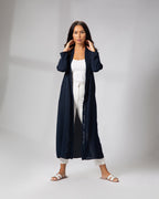 Full-length front view of a woman wearing the navy kimono, styled open with white outfit underneath KSA UAE Qatar