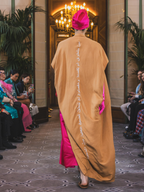 Model walking in camel kaftan back view showcasing Arabic embroidery designed by Omni The Label KSA UAE Qatar

