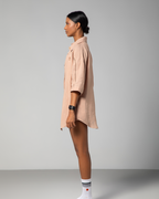 One side view of nude linen shirt and shorts set from Omni The Label, highlighting the loose fit and subtle detailing of the fabric UAE KSA Qatar