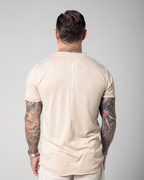 The image depicts the back view of a male model wearing a nude-colored Marbella V-neck T-shirt. The T-shirt is designed with a slub jersey texture, enhancing its breathability and comfort UAE KSA Qatar
