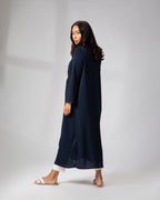 Side view of model wearing Omni The Label’s navy blue kimono, showcasing the open front and lightweight drape over a white ensemble KSA UAE Qatar